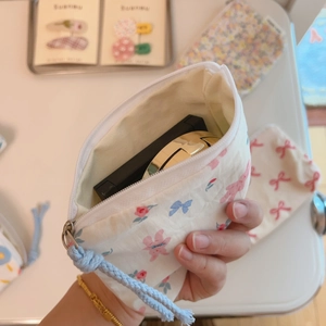 Macro view of blue floral bunny print fabric pouch showing internal storage capacity