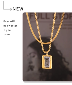 Detail of 18k gold layered necklace with rectangular zircon pendant and snake chain