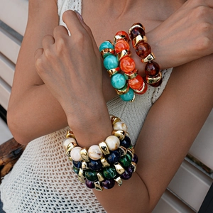 Detail of bohemian acrylic beaded bracelet set with amber and turquoise stones