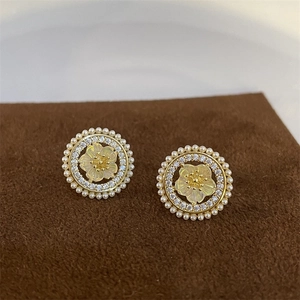 Detailed macro view of vintage flower earrings with pearls and pink cubic zirconia