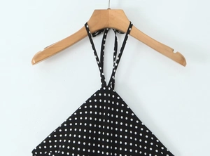 Detail of black and white polka dot halter neck top with tie-up neck design