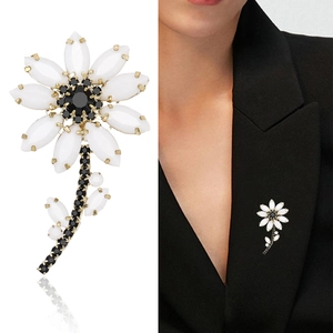 Elegant white daisy flower brooch pin with black petals and gold-tone finish for suits