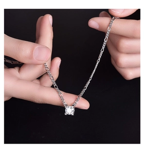 Detail of 925 sterling silver bull head necklace with 2ct moissanite on palm