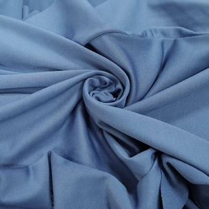Detailed macro view of the textured blue elastic fabric showing premium knit pattern