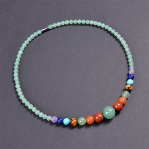Detail view of colorful natural stone beads with multi-color chakra crystal accents