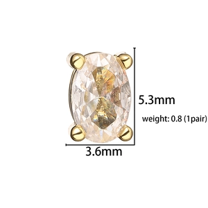 Detail view of oval cut clear zircon stud earring in gold prong setting with dimensions