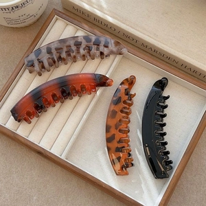 French vintage banana hair clip set in tortoise shell and black on a velvet tray