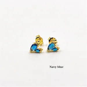 Detailed view of navy blue pear-shaped zircon stud earrings in gold-plated settings