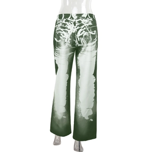 Detail view of green and white gradient printed wide-leg trousers on a model stand
