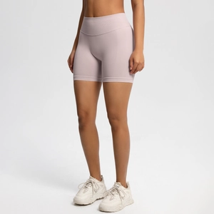 Close-up of high-waist seamless pink yoga shorts showing peach-lift fit and breathable fabric