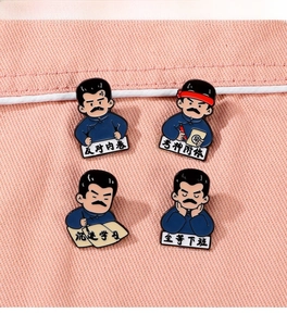 Set of four cartoon metal enamel pins with Lu Xun theme on pink fabric background