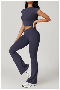 Side view of gray-blue yoga set with stand collar top and flared leggings
