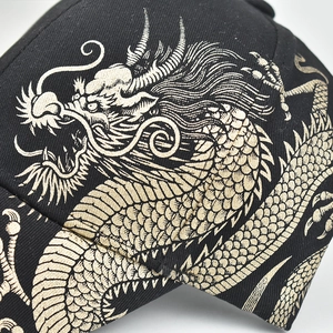 Close-up of golden Chinese dragon embroidery on high-quality black cotton baseball cap