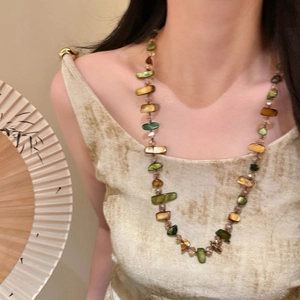 Vintage style double-layered beaded necklace with amber and green stones on a model