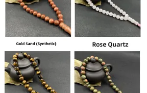 Detail of diverse natural gemstone prayer beads including rose quartz and tiger eye