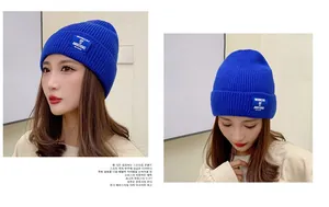 Detail view of royal blue ribbed beanie showing knit texture and square patch label