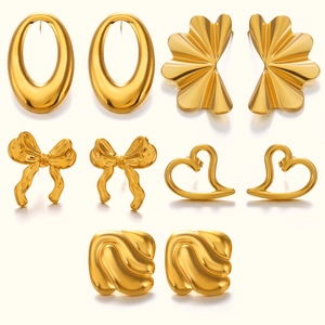 Elegant gold earrings set featuring oval heart and bow designs on a white background