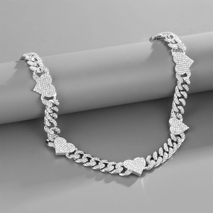 Silver Cuban chain necklace with iced-out heart pendants on a professional gray display