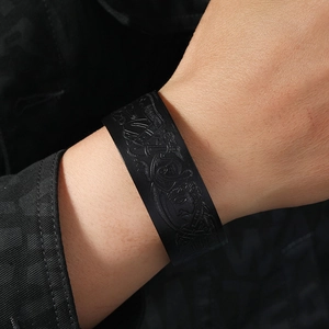 Close-up of black vintage leather bracelet with embossed Celtic patterns on wrist
