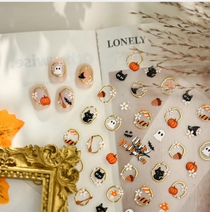 Macro detail of 5D Halloween nail art stickers with pumpkin, ghost and gold embossed edges