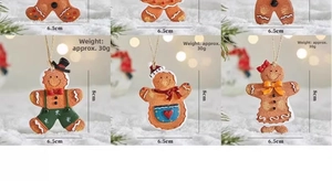 Close-up of resin gingerbread man ornaments with colorful details and hanging ropes
