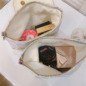 Macro view of floral jacquard makeup bags with zipper closure and thick canvas lining