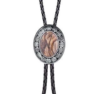 Detail of western bolo tie featuring engraved silver frame and agate stone inlay