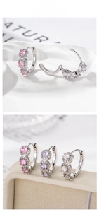 Detail of silver geometric earrings set with pink, purple and white cubic zirconia