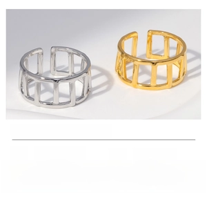 Detailed view of hollow leaf and heart design stainless steel ring in gold and steel finish
