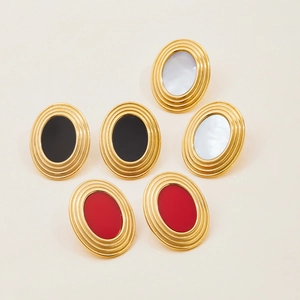 Detailed view of oval vintage earrings with 18K gold textured finish and colorful inlay