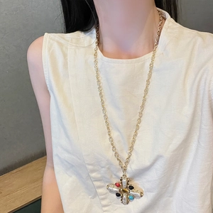 Gold French vintage cross necklace with colorful gemstones and baroque pearls on model