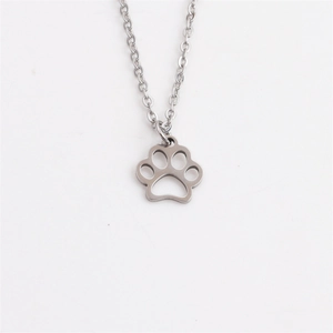 Detailed view of dog paw cut-out pendant in polished silver stainless steel jewelry