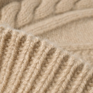 Winter chunky knit beanie in beige wool blend with classic cable stitch and soft texture