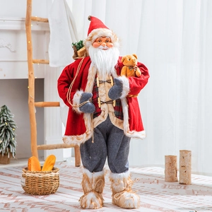 Standing Santa Claus doll with teddy bear in cozy home fireplace scene Christmas decor