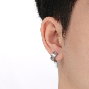 Detailed view of silver hoop earrings featuring engraved Roman numerals and click closure