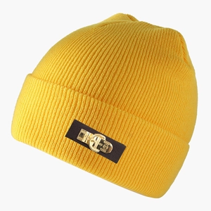 Close-up of yellow knit beanie featuring a leather patch with a metal 1999 G-logo emblem