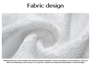 Macro shot of white lace fabric texture with washing instructions for Y2K style top
