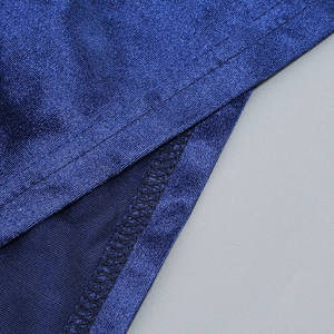 Close-up of starry blue evening gown fabric showing detailed metallic sheen and stitching