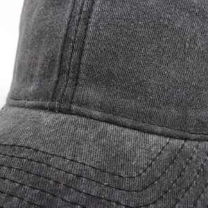 Close-up of vintage washed grey baseball cap showing detailed twill cotton texture and stitching