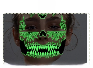 Glow-in-the-dark green skull face tattoo sticker showing luminous teeth and spider web