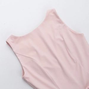 Detail of pink sleeveless dress neckline with elegant bow and smooth elastic fabric