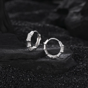 Elegant S925 sterling silver bamboo hoop earrings with white zircon on a dark background