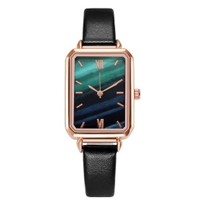 Detail of rectangular rose gold watch with green malachite dial and black leather strap