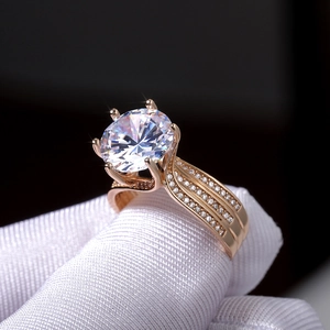 Macro shot of gold six-prong engagement ring featuring a large zircon and pavé setting