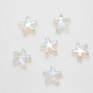 Macro view of six iridescent white starfish beads with a textured pearlescent finish