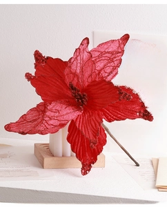 Close-up of artificial red poinsettia flower with glitter detail for Christmas decor