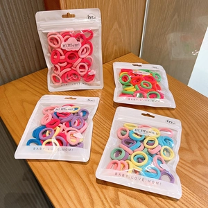 Elastic baby hair ties set in colorful pastel shades with clear pouch packaging