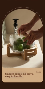 Close-up of glass bowl with vertical stripes texture on a wooden cross base