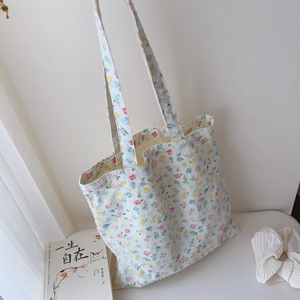Close-up of floral cotton tote bag with delicate floral pattern and decorative woven label