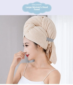 Detail of waffle texture coral fleece hair towel wrap with gray elastic band on a model